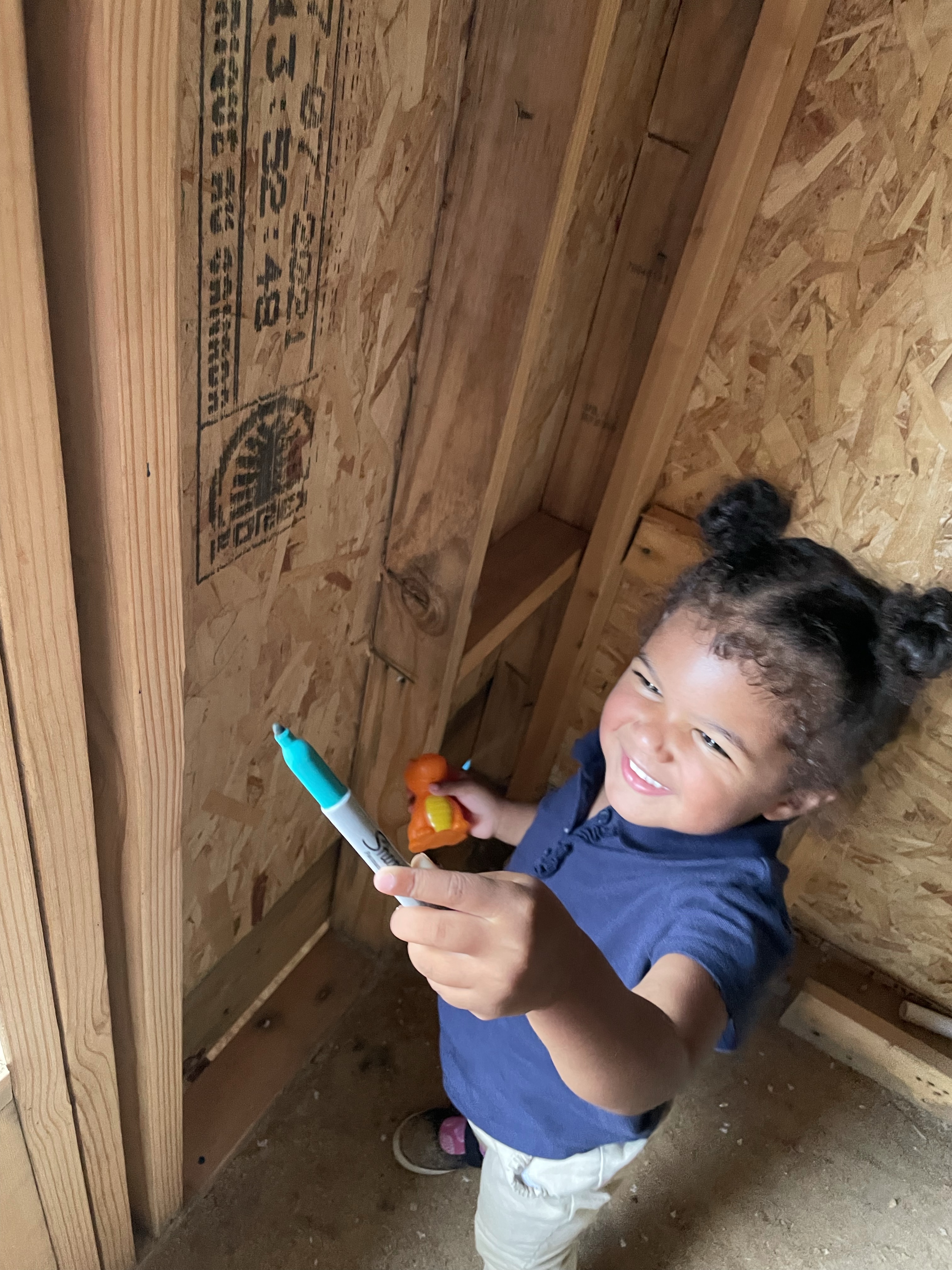 new-home-toddler-daughter-writing-on-the-foundation